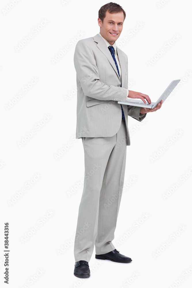 Side view of smiling businessman using his laptop Side view of smiling businessman using his laptop