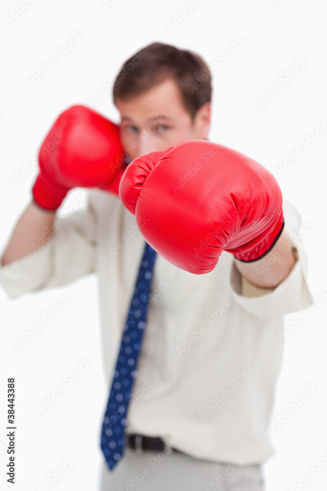 Attacking businessman with boxing gloves Attacking businessman with boxing gloves