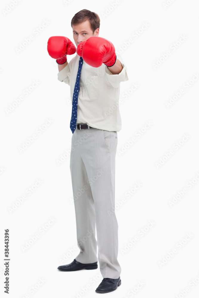 Businessman with boxing gloves in offensive position Businessman with boxing gloves in offensive position