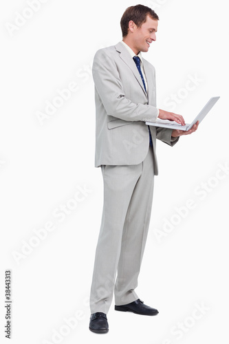 Side view of businessman working on his laptop