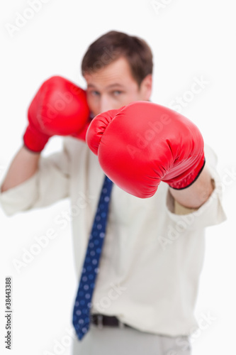Attacking businessman with boxing gloves