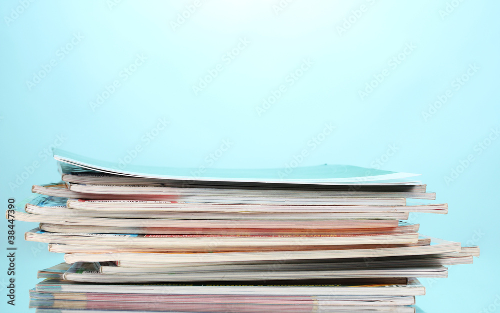 stack of magazines on blue background