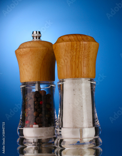 Salt and pepper mills on blue