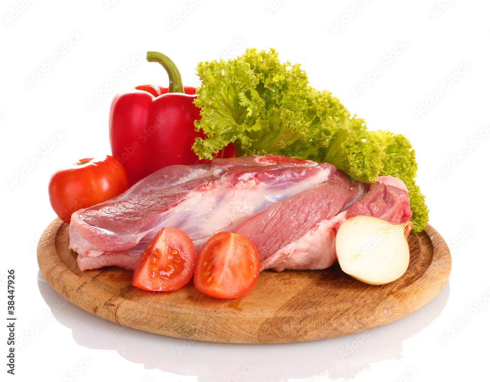 Raw meat and vegetables on a wooden board isolated on whitе Raw meat and vegetables on a wooden board isolated on whitе