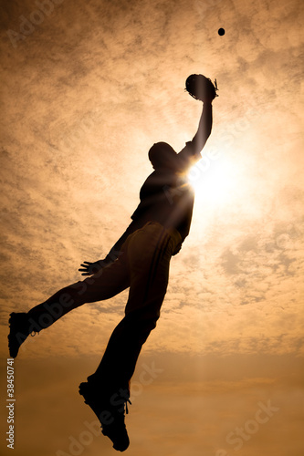 Canvas Print baseball player jumping into air to make the catch