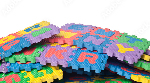 Pile of colorful alphabet blocks against white