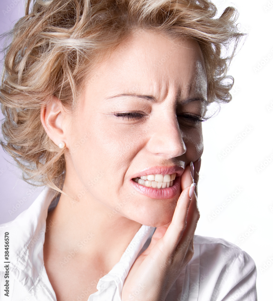 Young woman in pain is having toothache