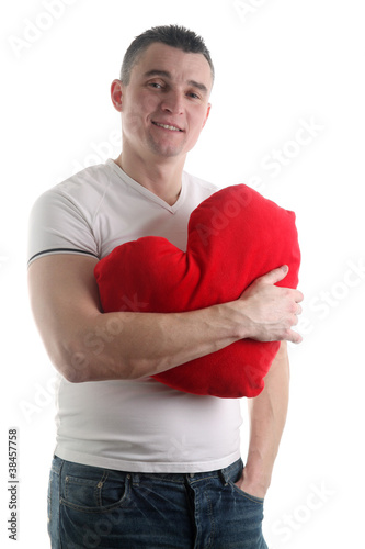 Man with a heart shaped pillow isolated on white background © IngridHS