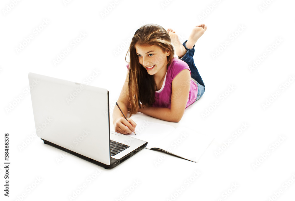College girl studying with some notebooks and a laptop computer College girl studying with some notebooks and a laptop computer