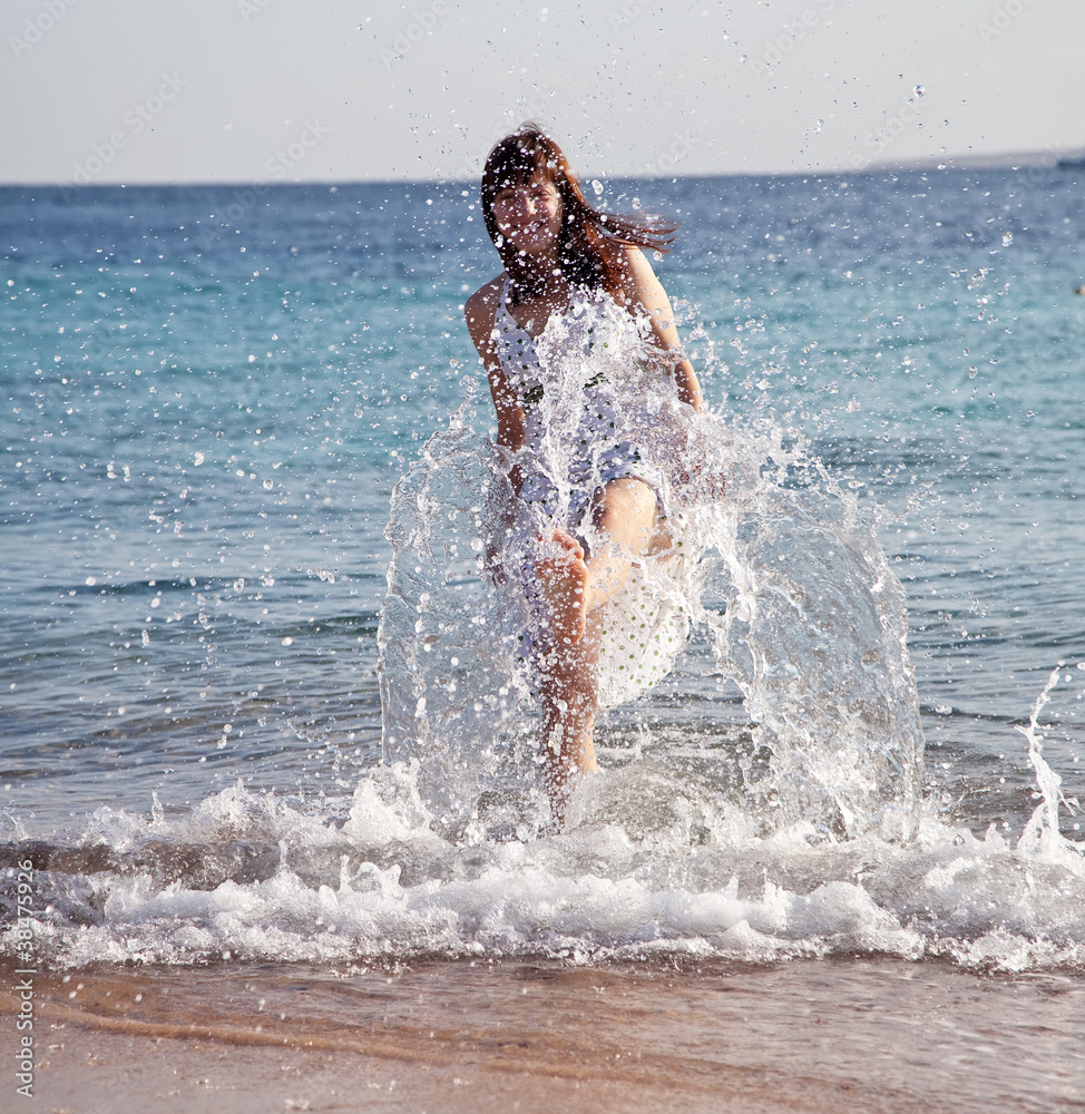 Happy  woman plays  at sea