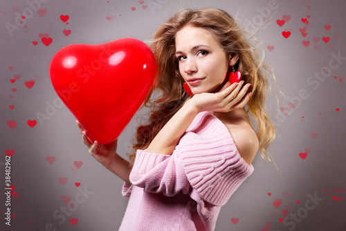 Valentines day woman holding red heart balloon