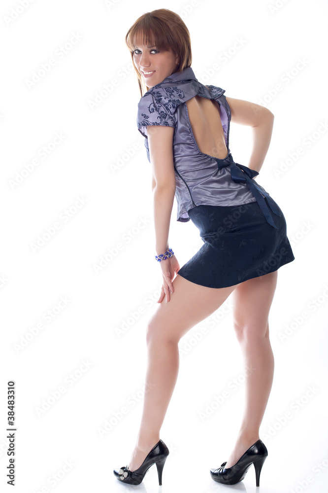 Young brunette woman a mini skirt isolated on a white background Young brunette woman a mini skirt isolated on a white background