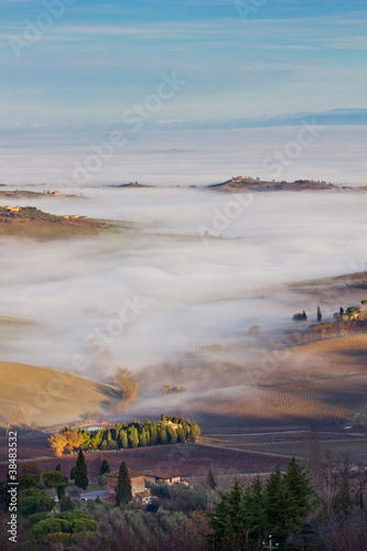 Tuscan landscape in the fog, Montepulciano (Italy).
