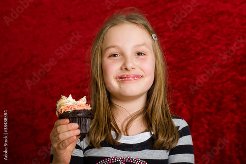 Photography young girl eating a delicious cupcake