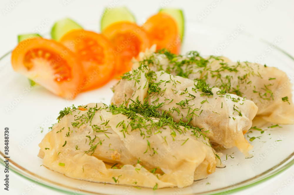 Stuffed cabbage on a plate against white