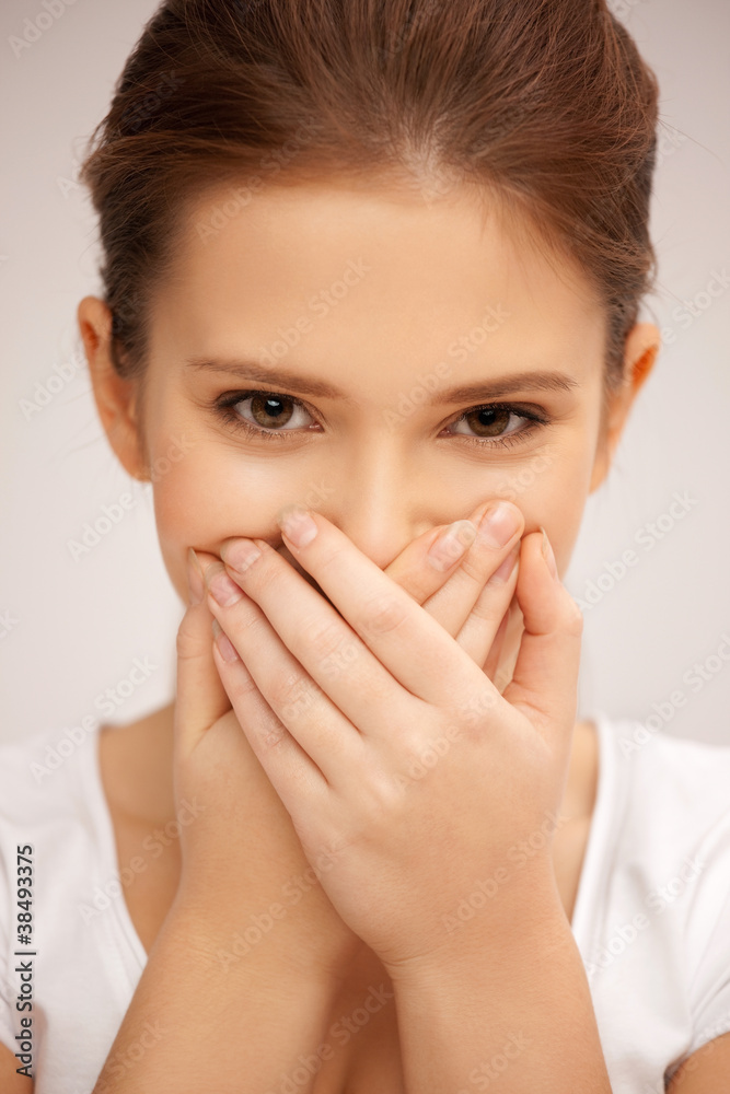 woman with hand over mouth woman with hand over mouth