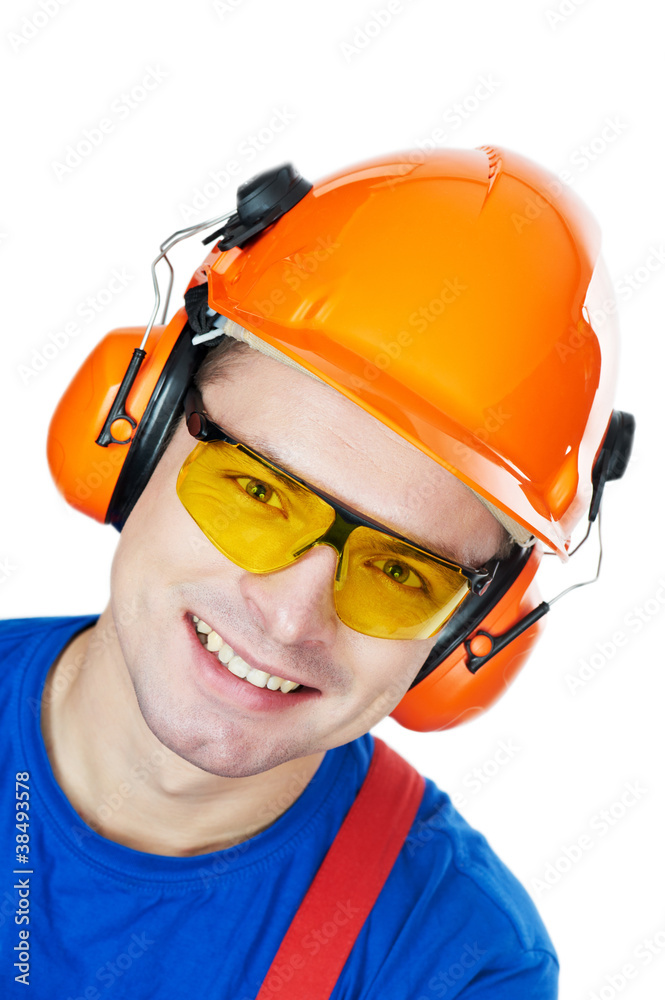 builder in hard hat, earmuffs and goggles builder in hard hat, earmuffs and goggles