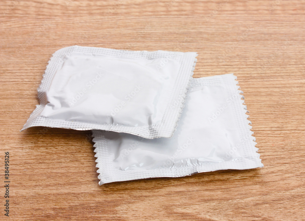 One condom on wooden background