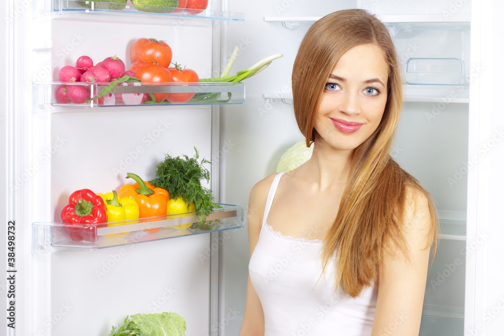 Picking food from fridge. Vegetables in the refrigerator Picking food from fridge. Vegetables in the refrigerator
