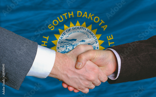 in front of american state flag of south dakota two businessmen photo