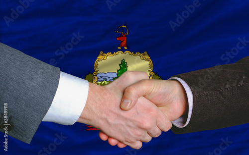 in front of american state flag of vermont two businessmen hands photo