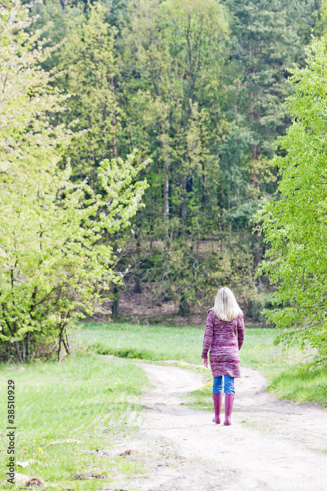 woman wearing rubber boots in spring nature woman wearing rubber boots in spring nature