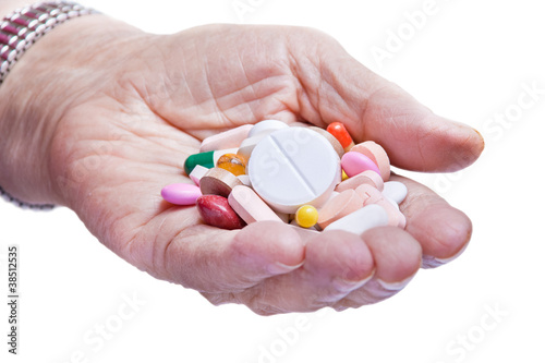 Old woman hand and pills