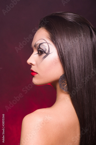 Portrait of a beautiful lady with art makeup