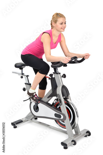 young woman doing indoor biking exercise