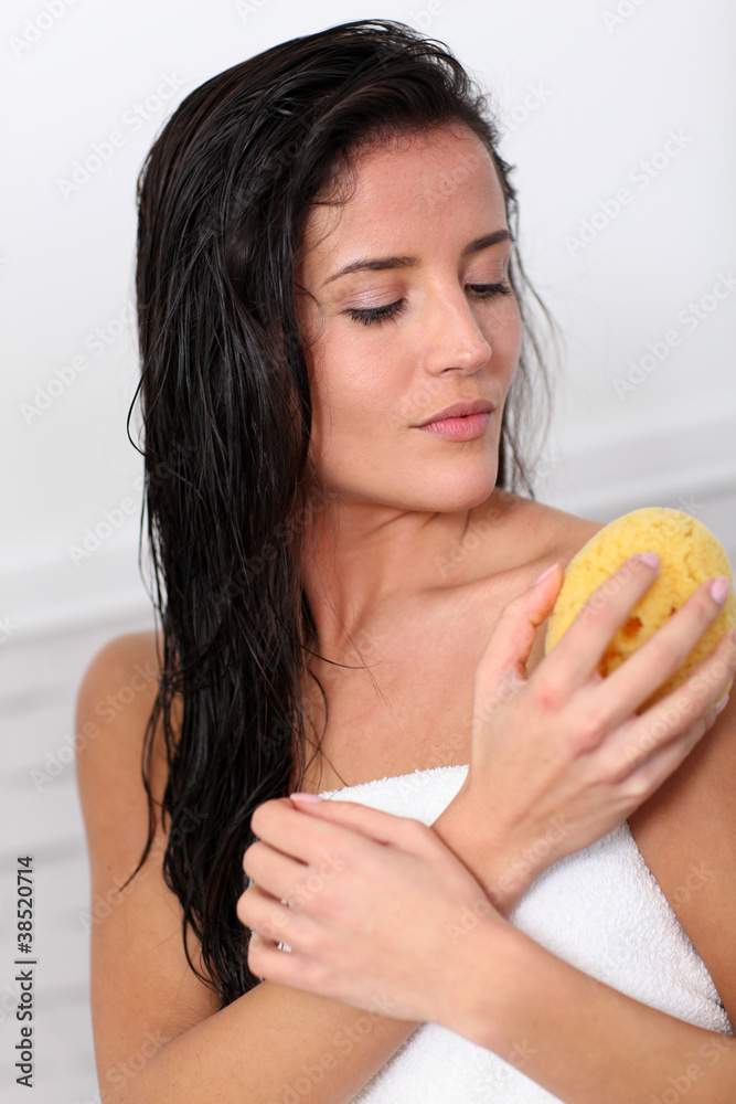 Attractive woman using natural sponge