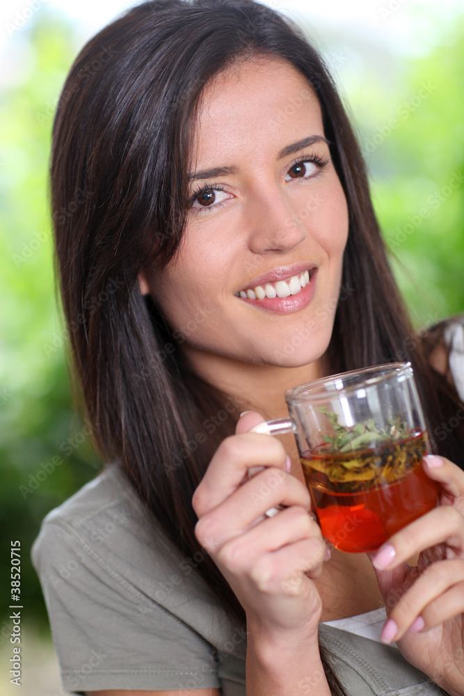 Portrait of young woman drinking herbal infusion Portrait of young woman drinking herbal infusion