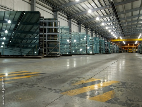 Large sheets of glass in a factory storage aera.