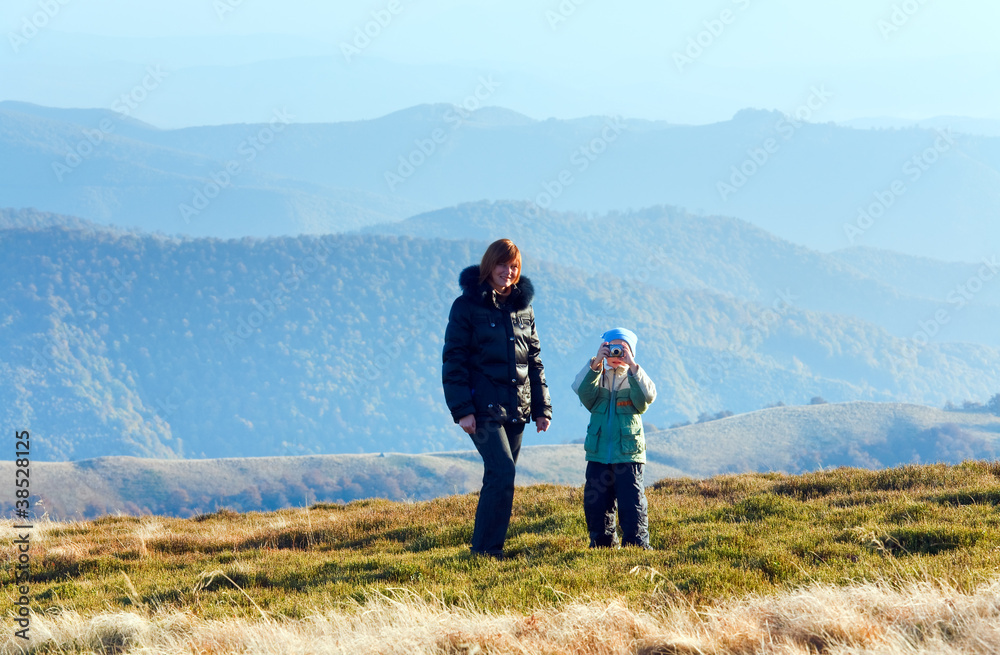Family make photo on autumn  mountain plateau