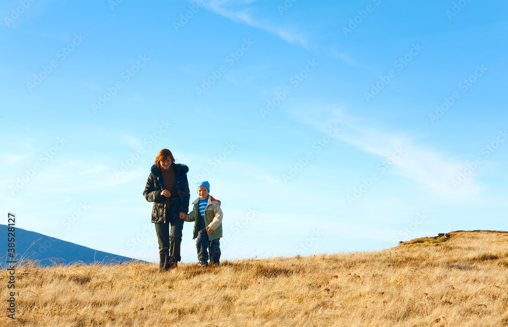Family walk on autumn  mountain plateau