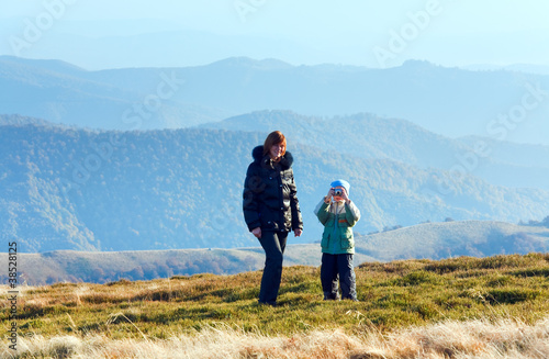 Family make photo on autumn mountain plateau