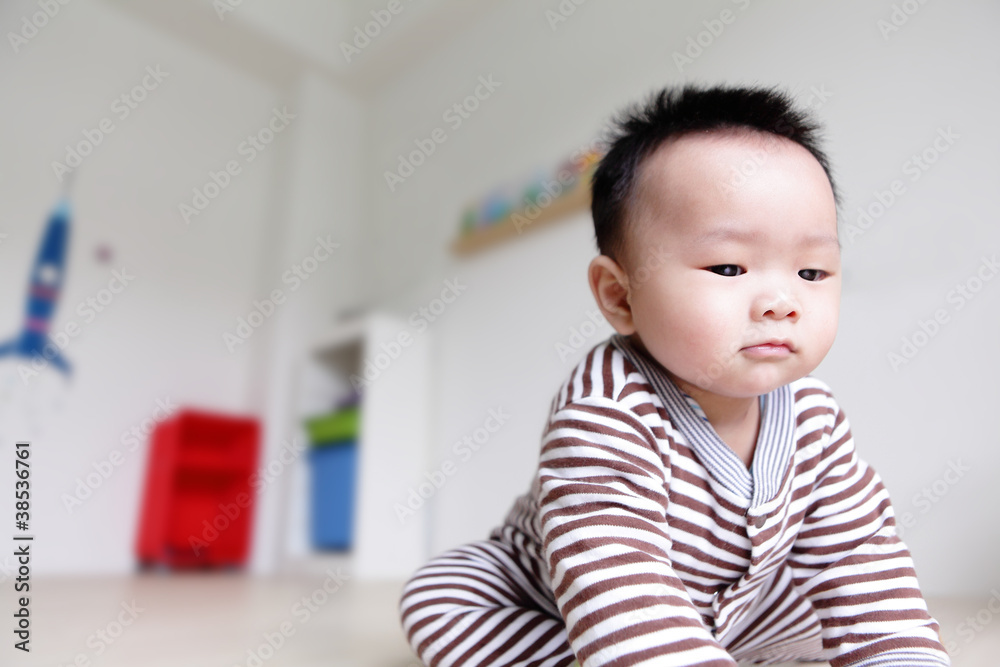 closeup of serious baby face with home backgroung closeup of serious baby face with home backgroung