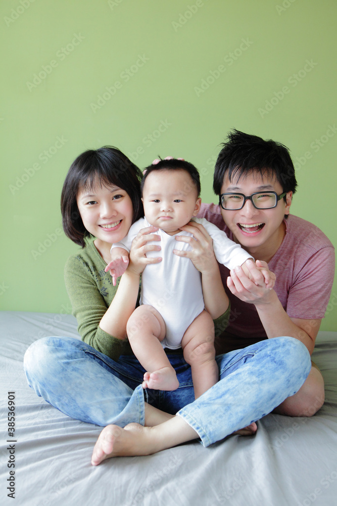 family (Mother, father and small baby) smile face