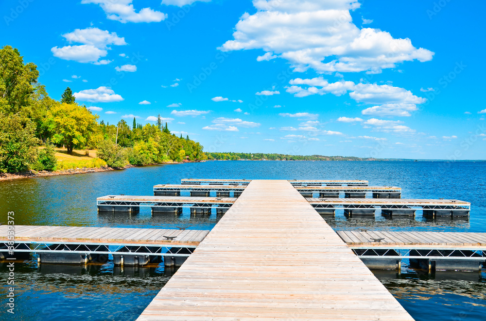 lake wooden pier against the blue sky