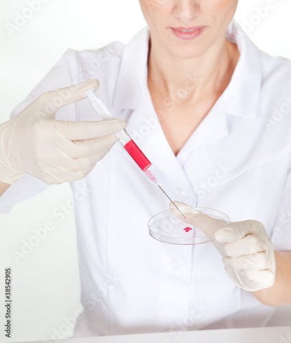 Putting contents of syringe onto petri dish