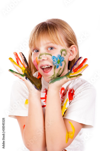 Beautiful little girl with hands painted in colorful paints
