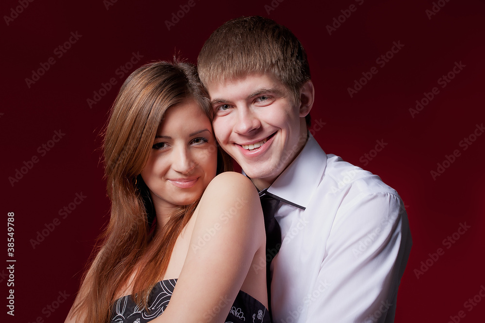 couple embracing on the red background couple embracing on the red background