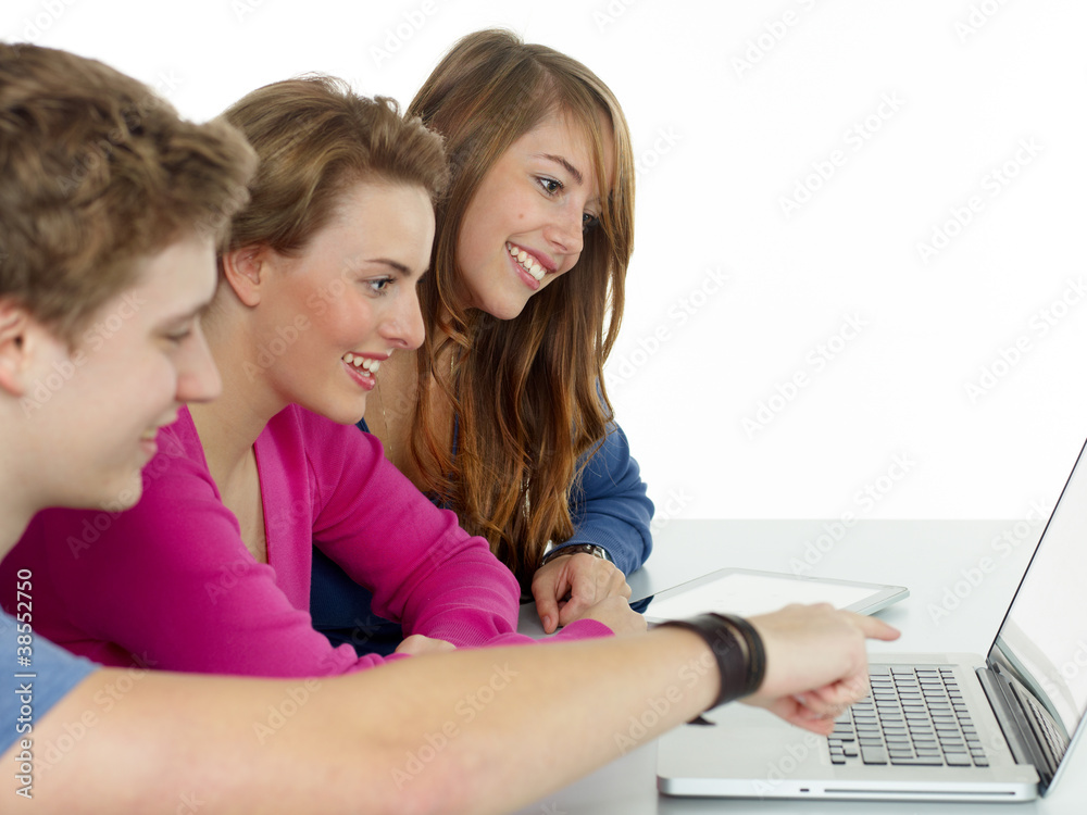 Friends surfing on the internet with touchpad and laptop Friends surfing on the internet with touchpad and laptop