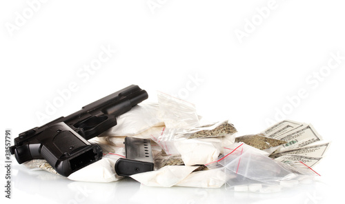 Cocaine and marijuana in packet with gun isolated on white