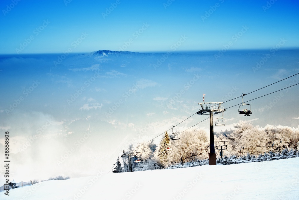 Winter landscape with a ski lift and ski slope Winter landscape with a ski lift and ski slope