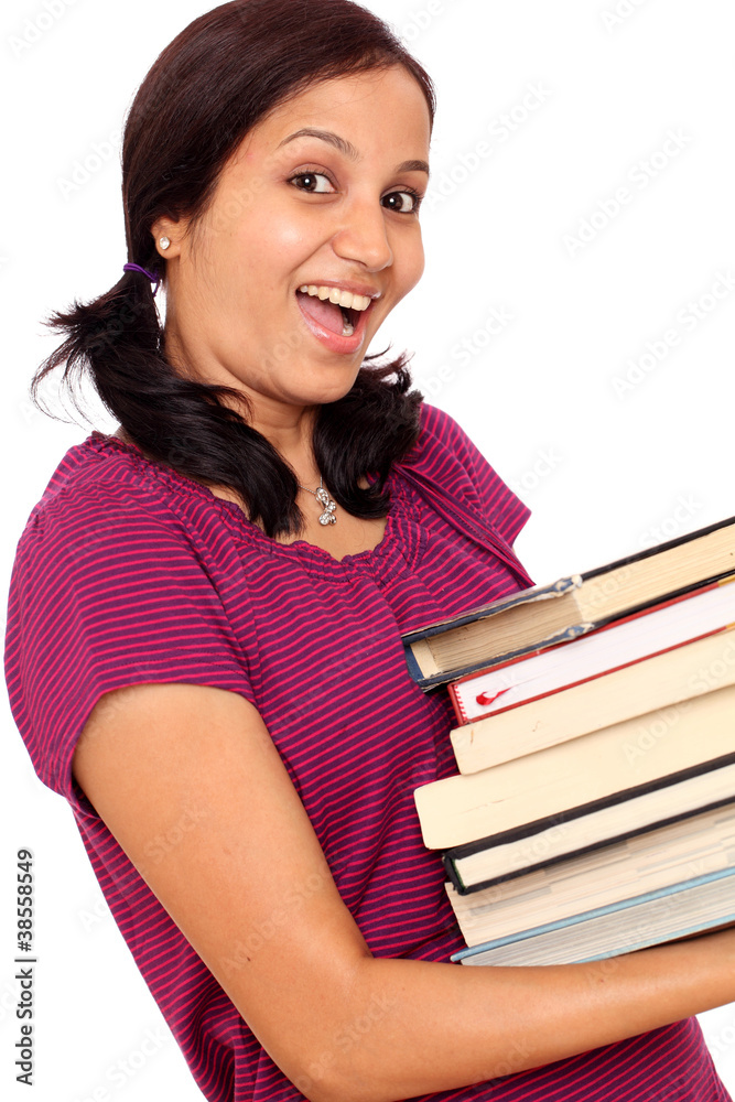 Female student making efforts to hold pile of books Female student making efforts to hold pile of books