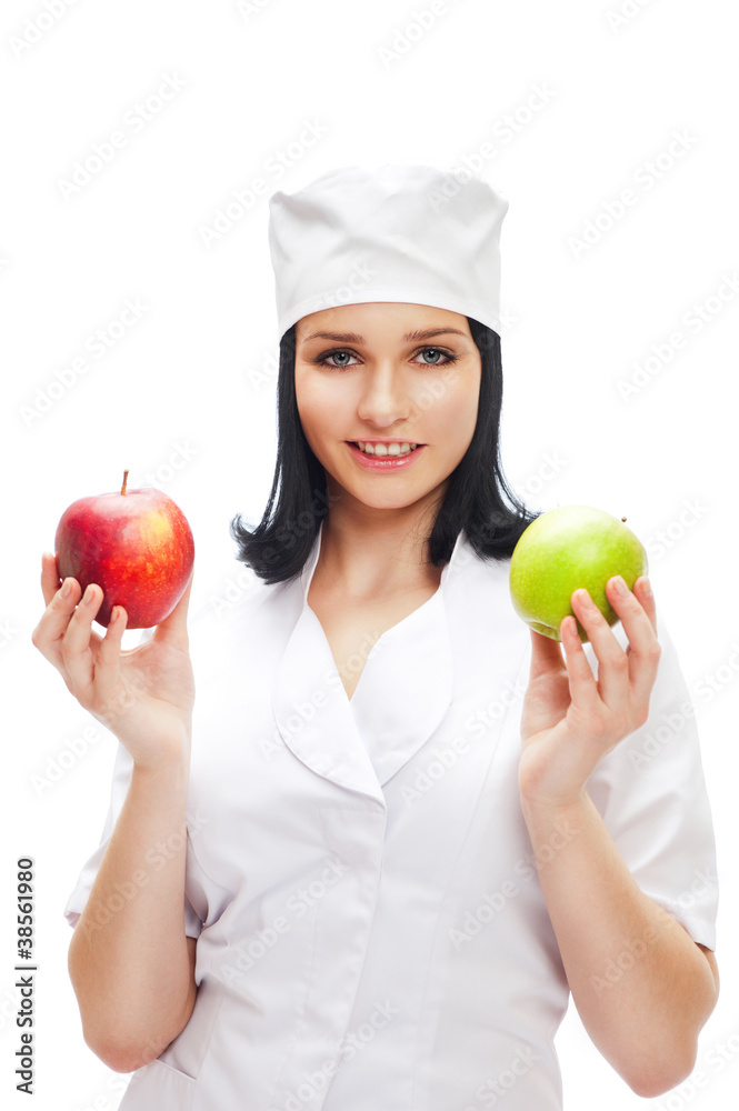 A female medical doctor holding a red and green apples in differ