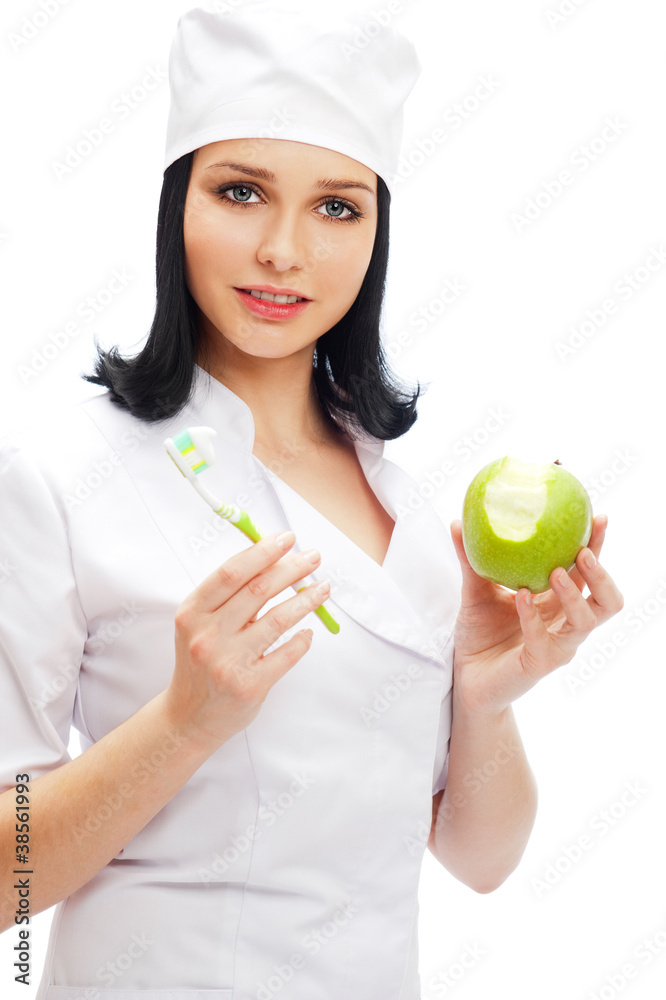 Beautiful young female dentist doctor with a toothbrush and gree Beautiful young female dentist doctor with a toothbrush and gree