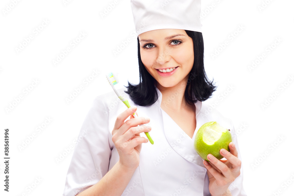 Beautiful young female dentist doctor with a toothbrush and gree Beautiful young female dentist doctor with a toothbrush and gree