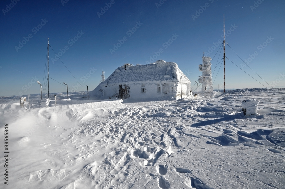 An ice-covered meteorological station, high on a mountain-top An ice-covered meteorological station, high on a mountain-top
