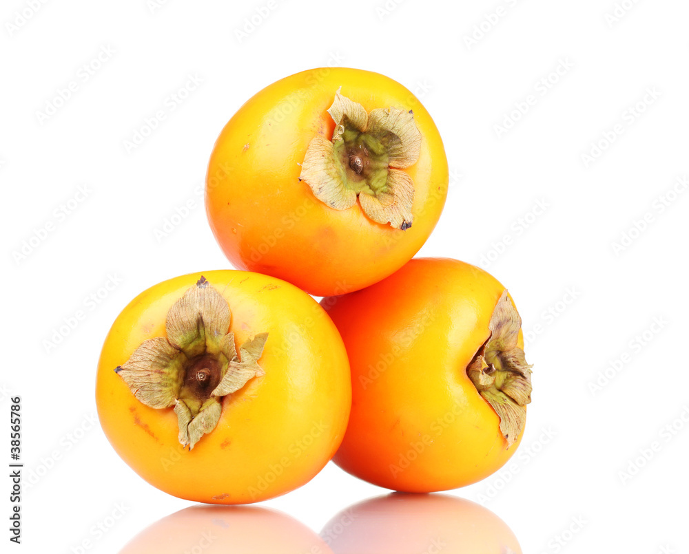 Three appetizing persimmons isolated on white Three appetizing persimmons isolated on white